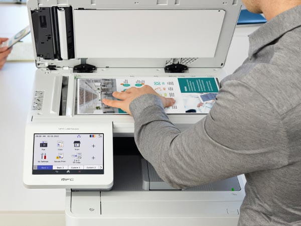 Person placing document on printer's scan glass